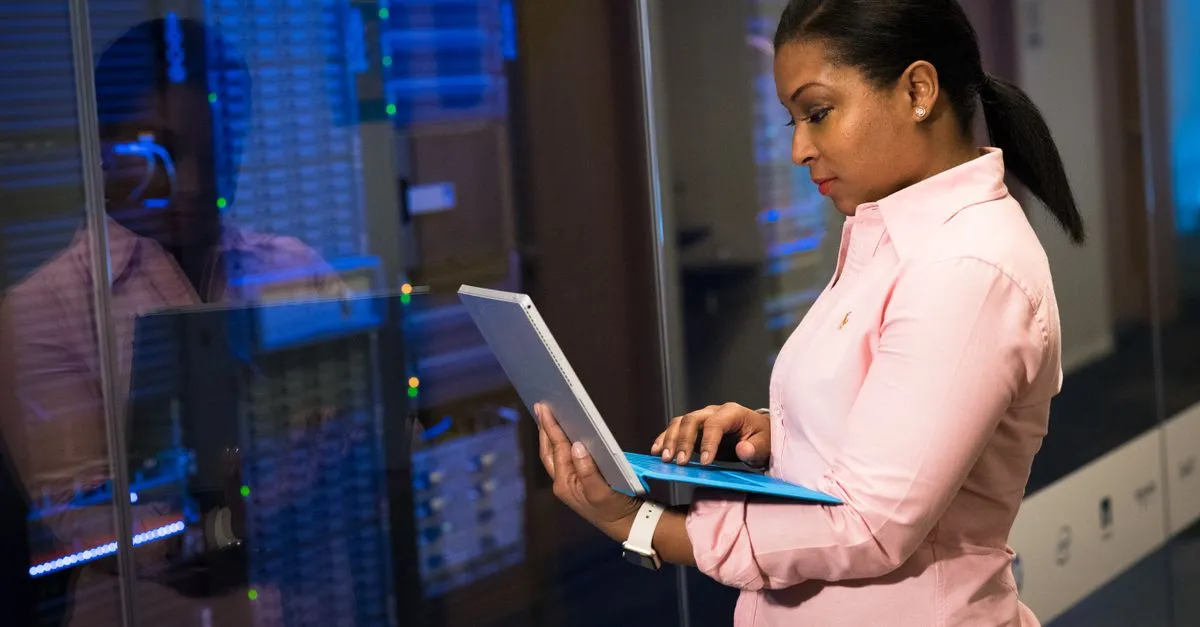 An IT engineer reviewing a business network setup with a laptop